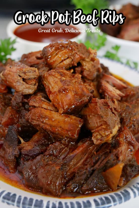 A white plate with blue trim with a serving of crock pot beef ribs.