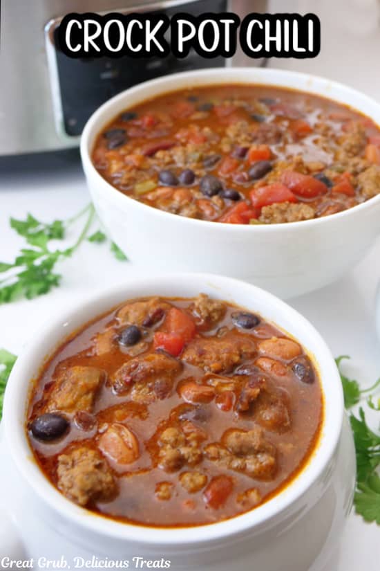 Two white bowls frilled with a serving of crock pot chili.