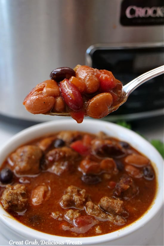 A close up of a spoonful of chili.