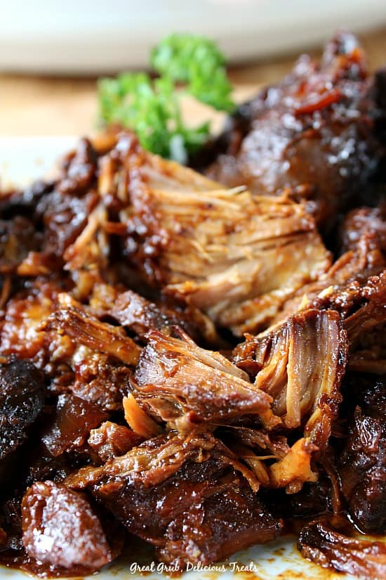 Crock Pot Country-Style Pork Ribs are fork tender, meaty and flavorful. A white plate with boneless pork ribs on it.
