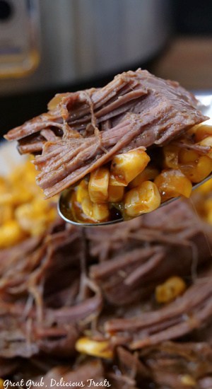 Tender chuck roast on a spoon with corn.