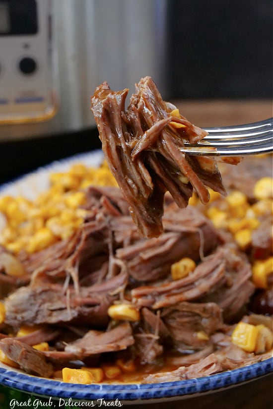 A bite of roast on a fork.