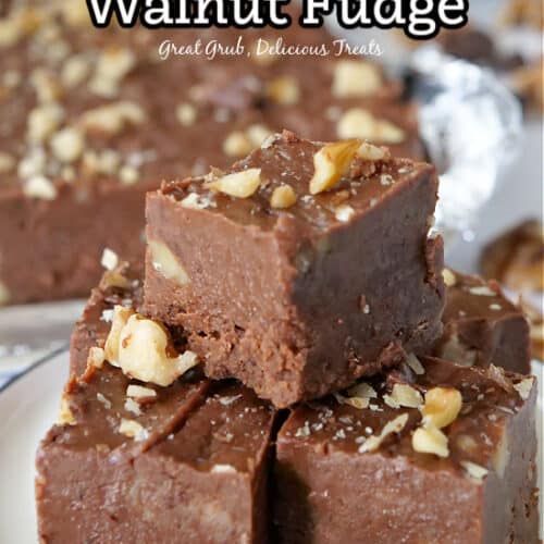 Three pieces of chocolate walnut fudge on a white plate.