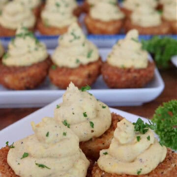 Three white plate with deep fried deviled eggs on them with the title overlay at the top.