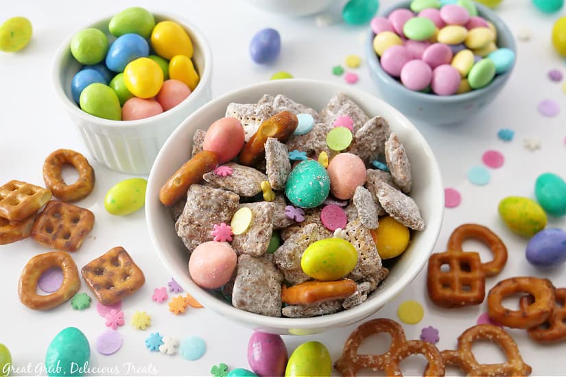 Two bowls filled with candies and one filled with muddy buddies.