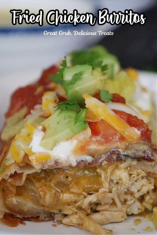 A fried chicken burrito with a bite cut off so the inside ingredients are showing.