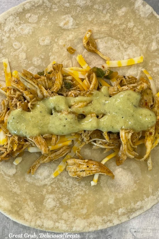 A flour tortilla with creamy poblano sauce added to shredded chicken and shredded cheese.