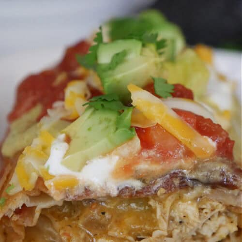 A fried chicken burrito cut in half showing the inside ingredients with the title at the top of the photo.