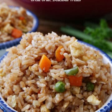 A white bowl with blue trim filled with a serving of fried rice.