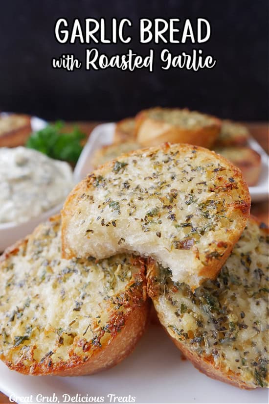 A white plate with three small round pieces of garlic bread on it.