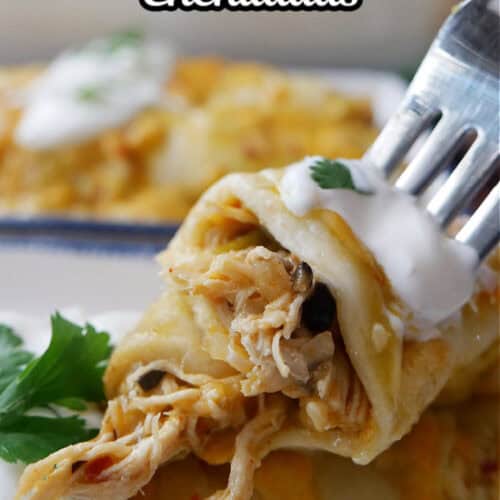 A bite of chicken enchilada on a fork.