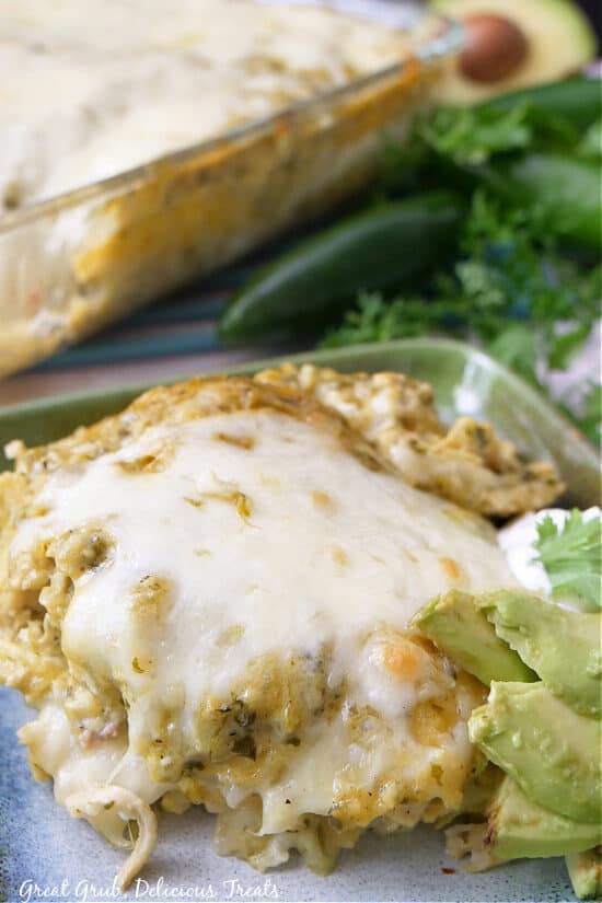A serving of chicken enchilada casserole on a square plate.