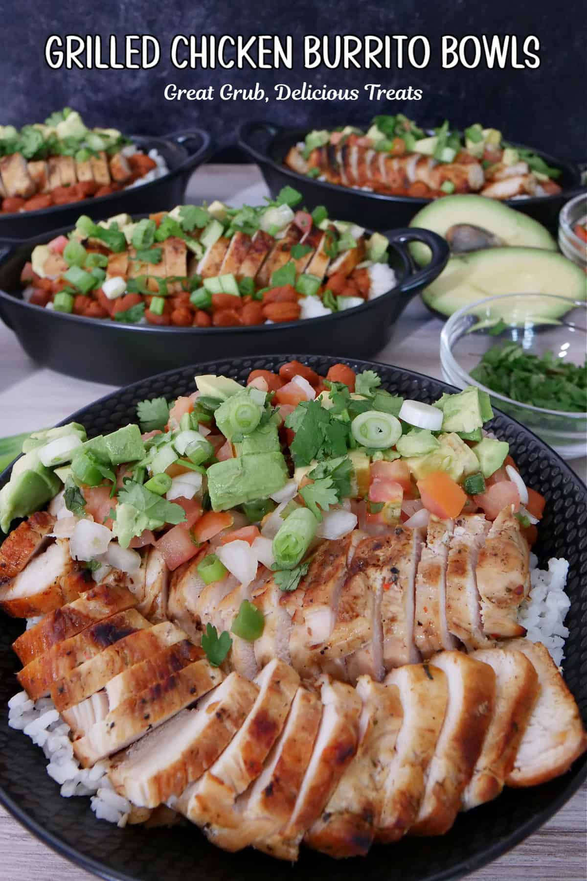 A white surface with grilled chicken, rice, avocado, pico in black bowls.