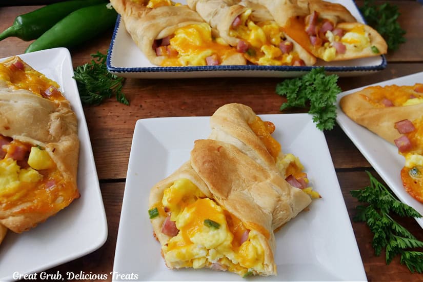 A few white plates with breakfast crescents on them.