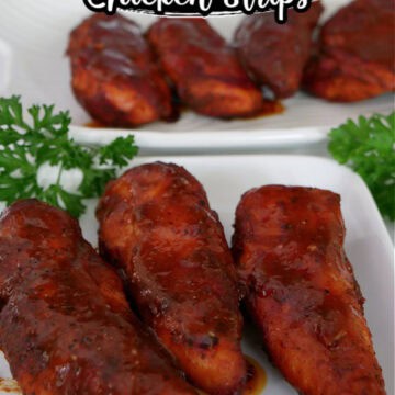 Two white plates with smoked hot honey BBQ chicken strips on them.