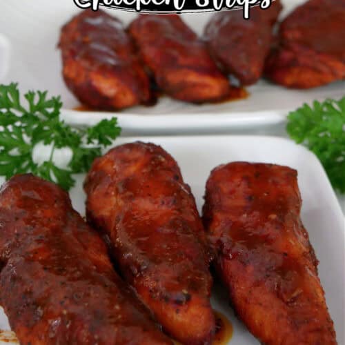 Two white plates with smoked honey BBQ chicken strips on them.