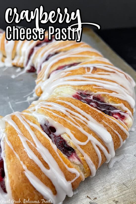 A baking sheet showing half of a cranberry cheese pastry ring on it.