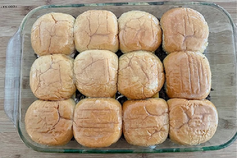 !2 sliders in a glass baking dish before being baked.