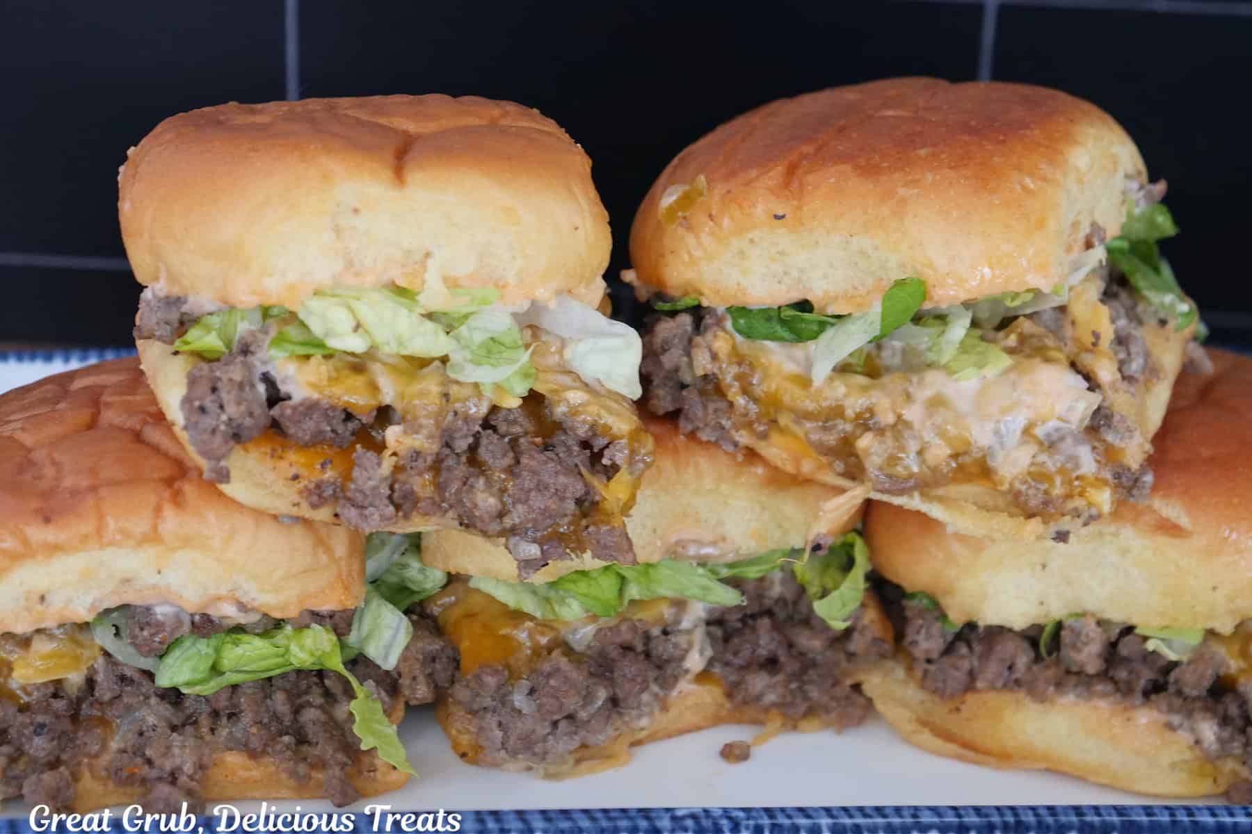 A stack of In N Out Sliders on a white plate with blue trim.