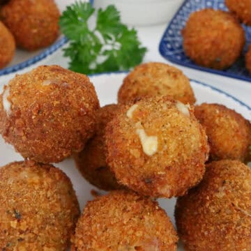A white plate with a small stack of Italian sausage bites.
