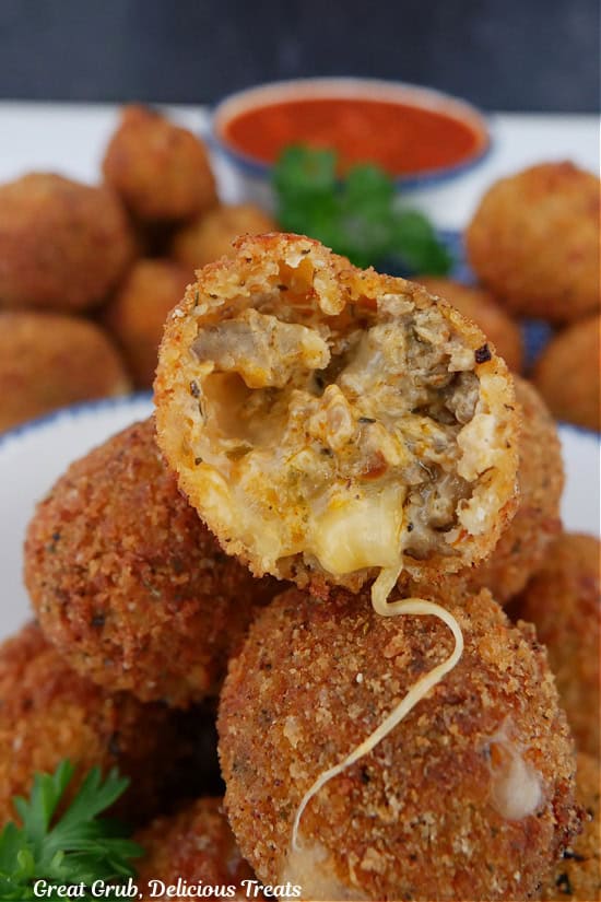 A small stack of Italian sausage bites with a bite taken out of the one on top.