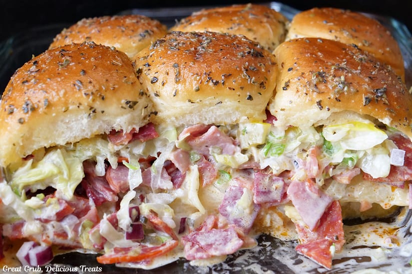 A horizontal photo of six chopped Italian sliders in a glass baking dish.