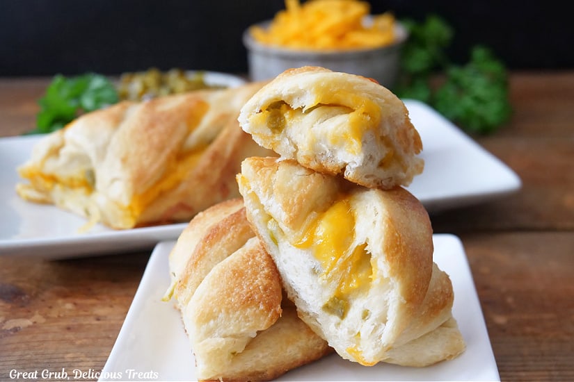 A horizontal photo of cheese bread on a white plate.