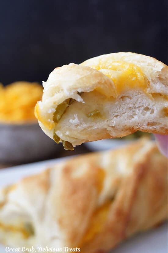 A slice of cheese bread held up to the camera lens.
