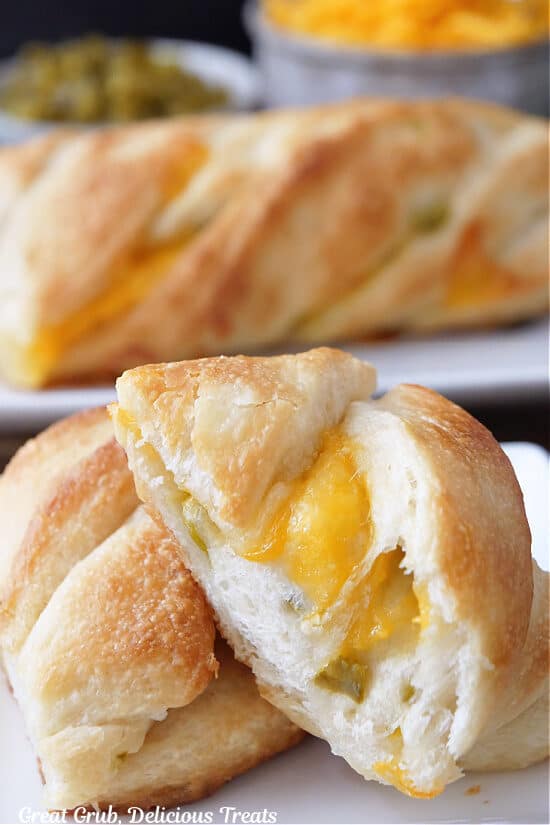 A close up of two slices of jalapeno cheddar bread on a white plate.