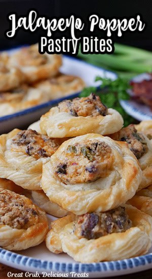 A white plate with blue trim with a stack of mini jalapeno popper pastries on it.