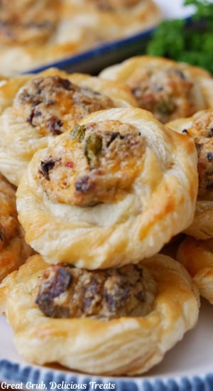 A close up of a plate filled with bite-size pastries filled with jalapeno popper mixture.