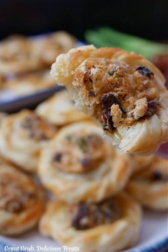 A bite-size puff pastry with a bite taken out of it.