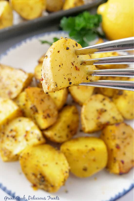 A fork with a bite of potato on it.