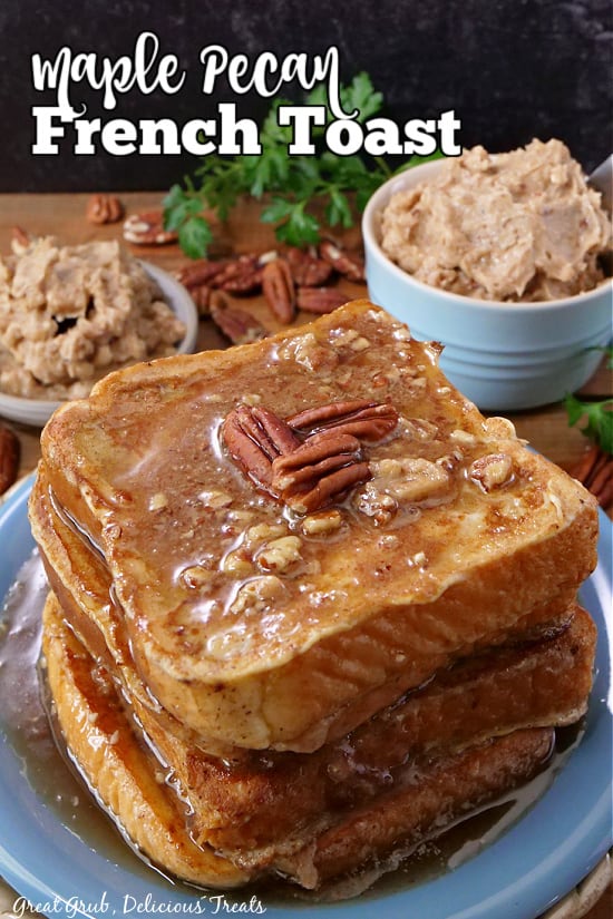 A stack of french toast on a blue plate, covered with syrup, pecans, and maple pecan butter.