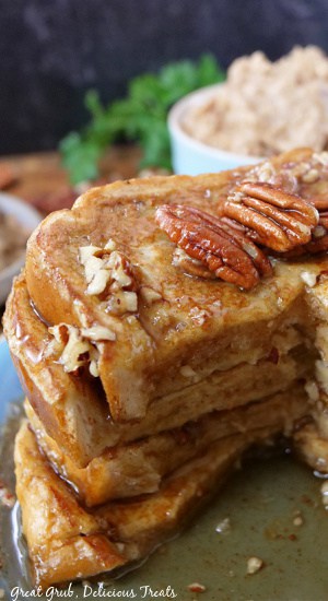 Maple Pecan French Toast is a delicious breakfast recipe that the whole family will enjoy. A big slice taken out of a stack of French toast.