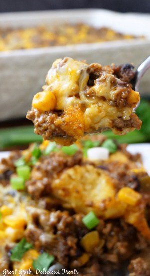 A close up of a spoonful of Mexican tamale pie on it.