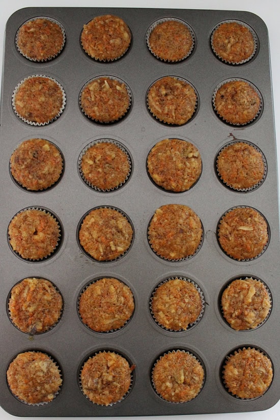 A mini muffin tin with the baked mini carrot cake cupcakes in it.
