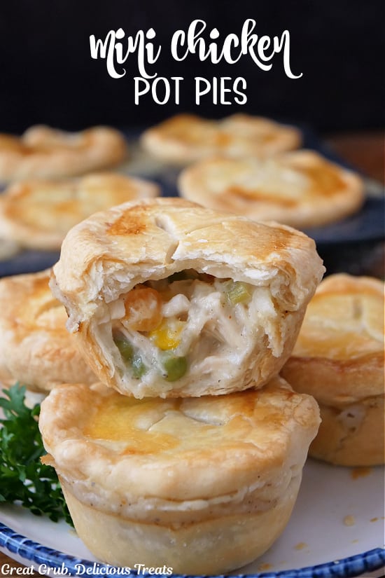 Seven mini chicken pot pies with a bite taken out of one of them.