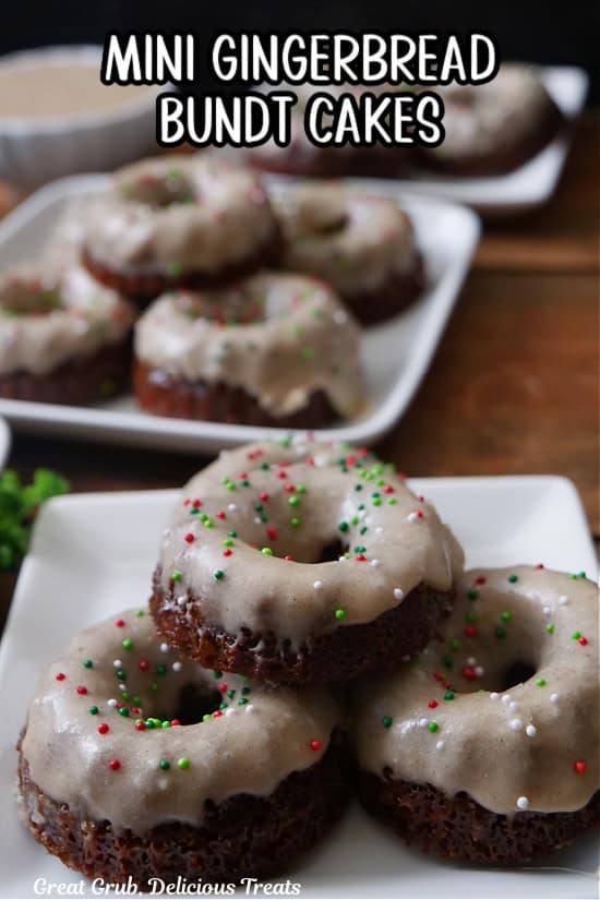 Two square white plates with mini gingerbread bundt cakes on them.