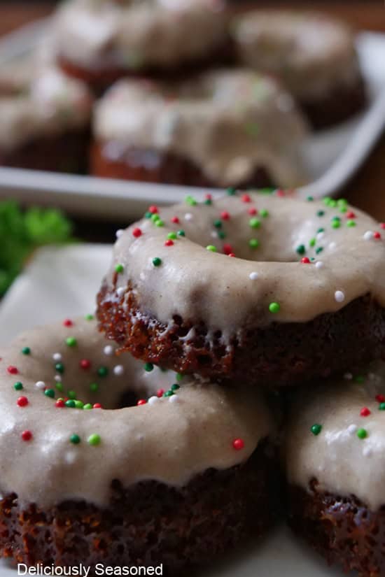 Three mini gingerbread bundt cakes with honey vanilla icing and candied sprinkles on top.