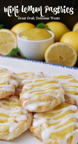 A qhite plate with blue trim with a half dozen mini lemon pastries on it.