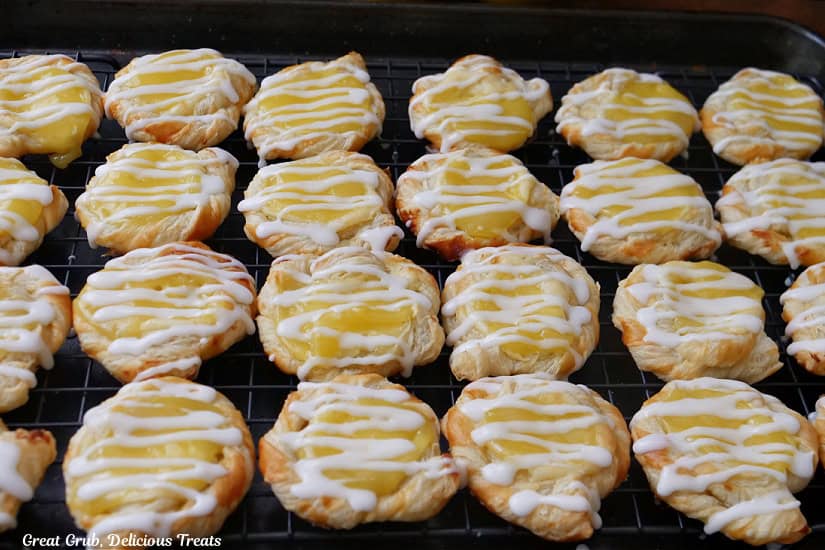 24 mini lemon pastries on a wire rack.