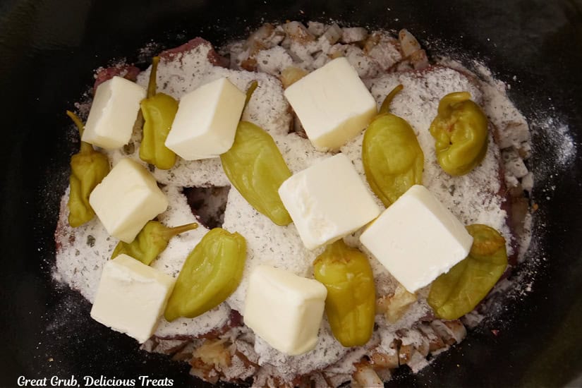 Pats of butter added to the crock pot.
