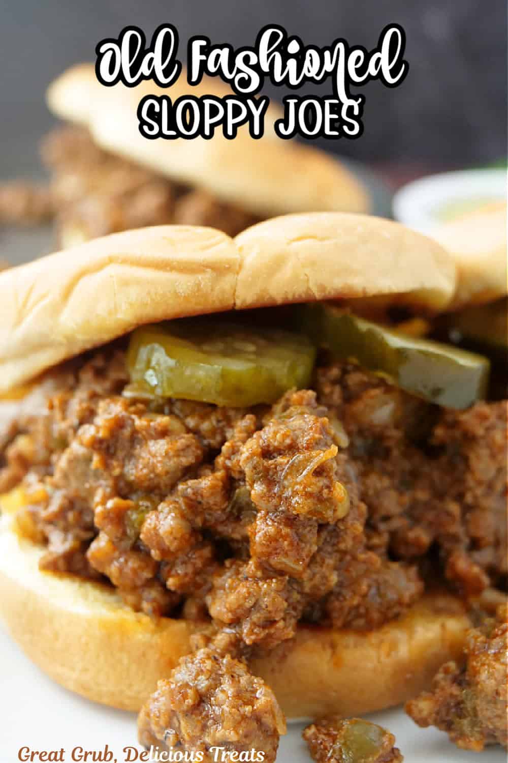 A sloppy joe on a counter with the title of the recipe in text at the top.