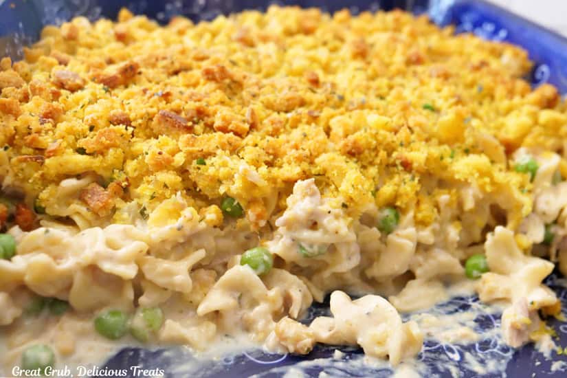 A blue baking dish with old fashioned tuna noodle casserole in it.