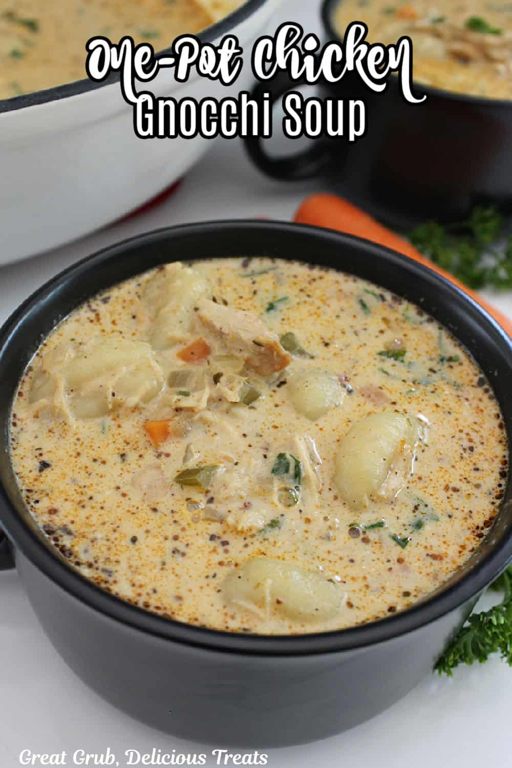 A black soup bowl with handles filled with homemade chicken gnocchi soup.