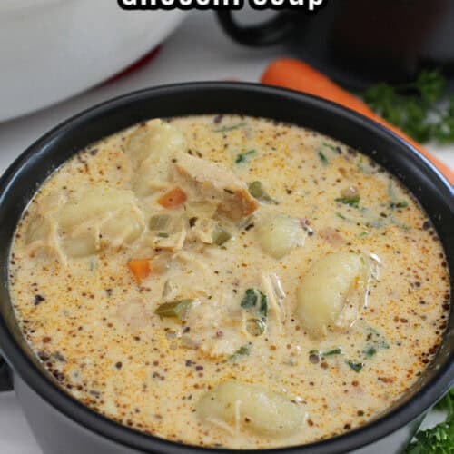 A black soup bowl filled with homemade chicken gnocchi soup.