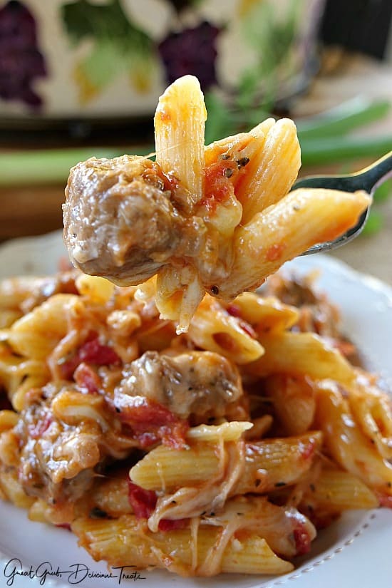 Italian Sausage Penne Casserole A bite of sausage and pasta on a fork.