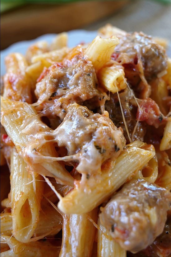 Italian Sausage Penne Casserole A large serving spoon filled with a heaping spoonful of pasta.