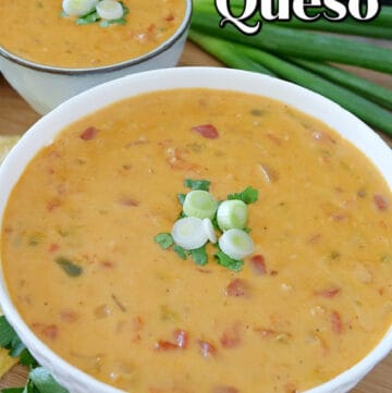 A close up shot of spicy queso in a white bowl and a small white bowl filled with queso in the background.